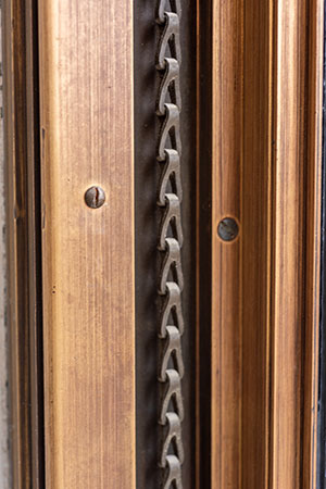 detail of restored bronze chain for windows