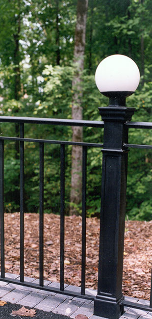 detail of black cast iron newel post located in a park setting