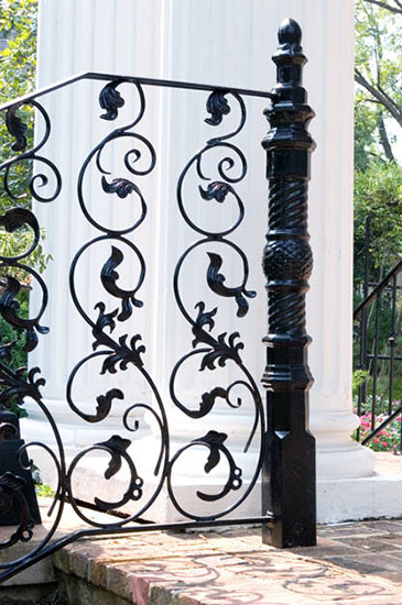 spiral newel post and decorative fencing in garden