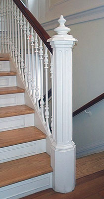 white newel post on stairs of snug harbor home